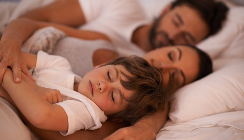 Família (pai, mãe e filho) deitados dormindo na cama. Filho sem estar com o nariz entupido, noite tranquila. 